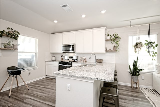 kitchen featuring light hardwood / wood-style flooring, stainless steel appliances, white cabinets, and sink