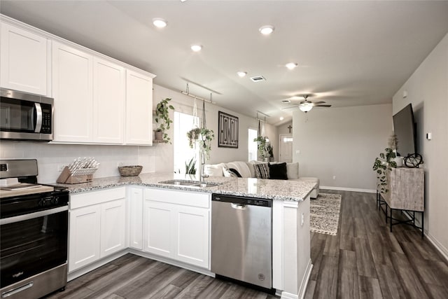 kitchen with stainless steel appliances, white cabinetry, ceiling fan, and kitchen peninsula