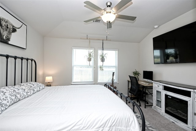 carpeted bedroom with ceiling fan with notable chandelier and lofted ceiling