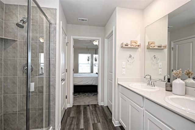 bathroom with a shower with door, hardwood / wood-style flooring, and vanity