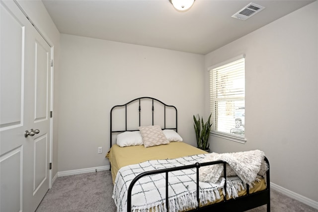 bedroom featuring light carpet