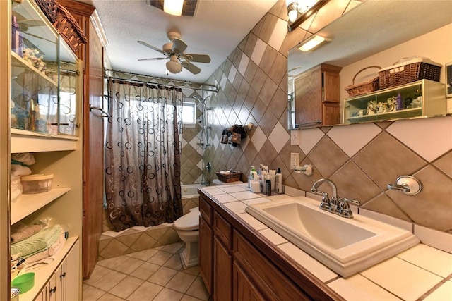 4525 Bell Springs Rd, Dripping Springs, TX 78620 - bathroom featuring shower / bathtub combination with curtain, vanity, a ceiling fan, toilet, and tile walls
