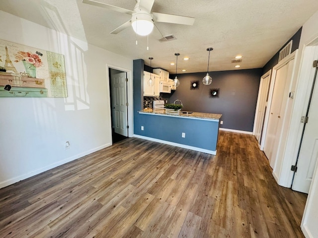 1624 Aquarena Springs Dr Unit G154, San Marcos, TX 78666 - kitchen featuring white appliances, a peninsula, dark wood finished floors, a ceiling fan, and a textured ceiling
