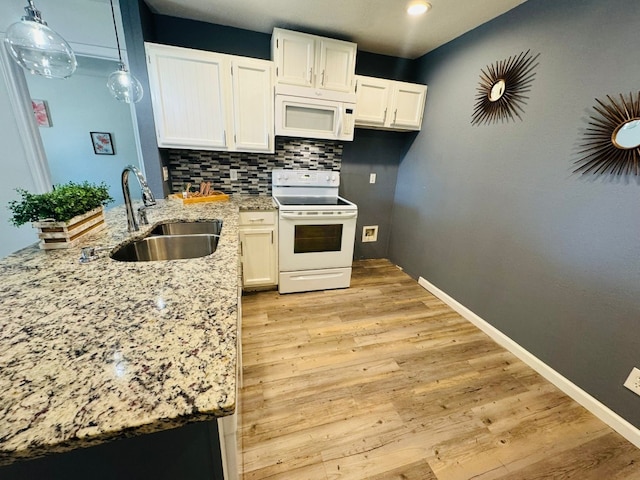 1624 Aquarena Springs Dr Unit G154, San Marcos, TX 78666 - kitchen featuring white appliances, light stone counters, white cabinets, a peninsula, and decorative backsplash