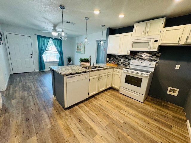 kitchen with sink, white cabinetry, hanging light fixtures, kitchen peninsula, and white appliances