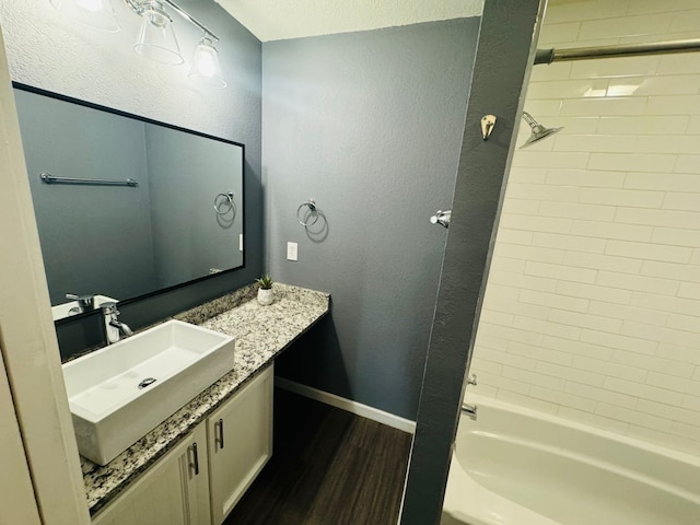1624 Aquarena Springs Dr Unit G154, San Marcos, TX 78666 - full bath featuring wood finished floors, vanity, bathing tub / shower combination, and a textured wall
