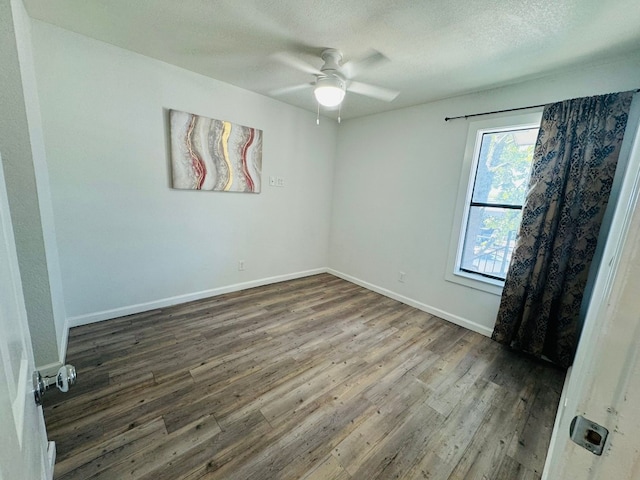 1624 Aquarena Springs Dr Unit G154, San Marcos, TX 78666 - empty room with wood finished floors, a ceiling fan, and a textured ceiling