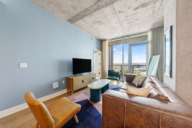 48 E Ave Unit 2511, Austin, TX 78701 - living room featuring wood finished floors, baseboards, and floor to ceiling windows