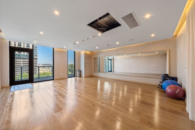 48 E Ave Unit 2511, Austin, TX 78701 - exercise area featuring light wood finished floors, recessed lighting, and baseboards