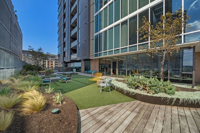 view of home's community with a deck and a lawn