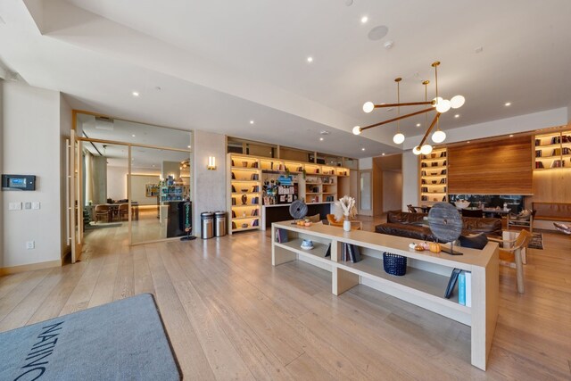 interior space with light wood-type flooring and a chandelier