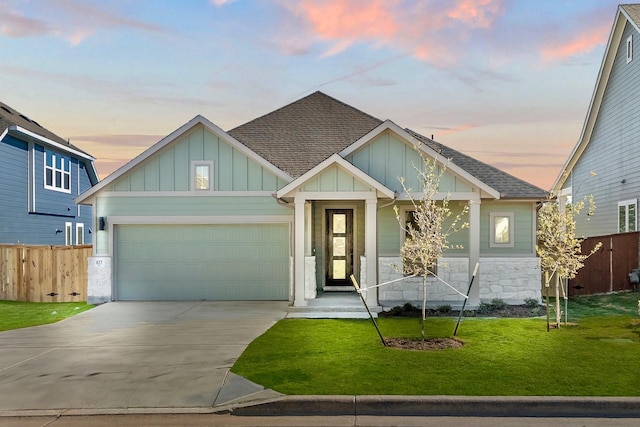 craftsman-style home featuring a yard and a garage