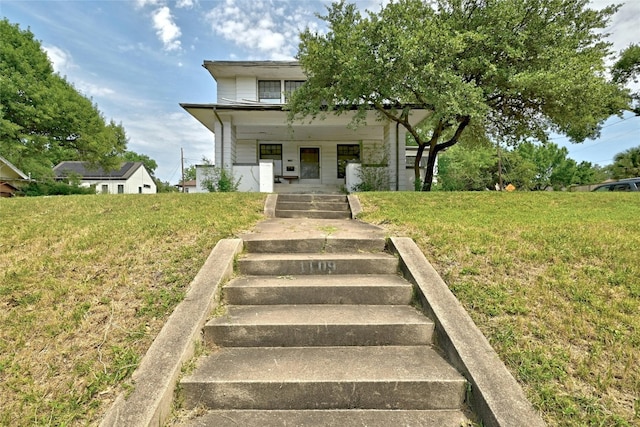 view of front of house featuring a front lawn and covered porch