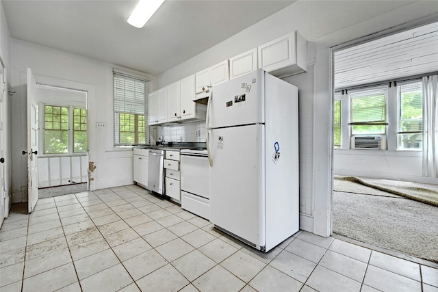 kitchen featuring light tile patterned flooring, white cabinetry, white appliances, and a wealth of natural light