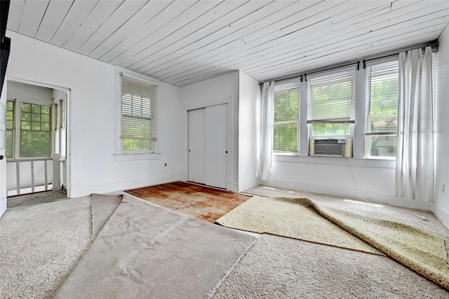 entrance foyer featuring wood ceiling, hardwood / wood-style floors, and plenty of natural light