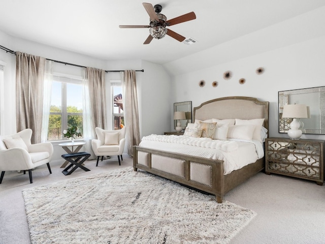 carpeted bedroom featuring lofted ceiling and ceiling fan