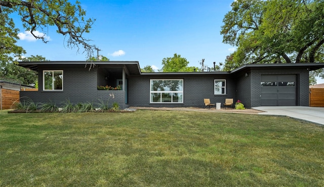 single story home with a garage and a front yard