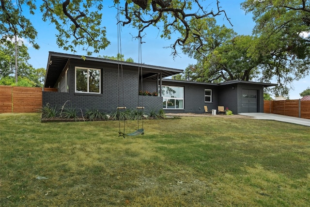 view of front of house with a garage and a front yard