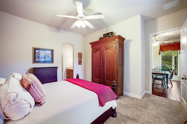 carpeted bedroom featuring ceiling fan and ensuite bathroom