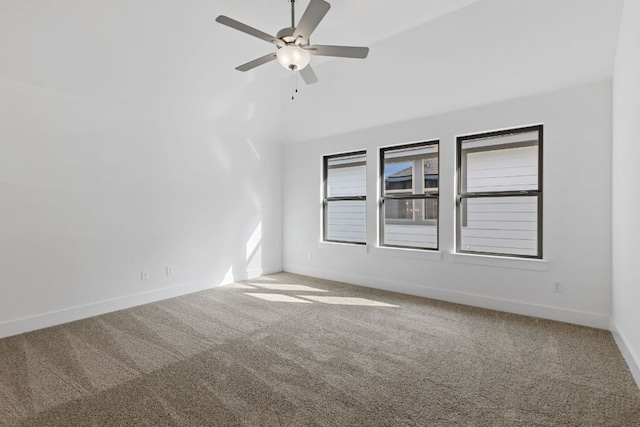 carpeted empty room with a ceiling fan and baseboards