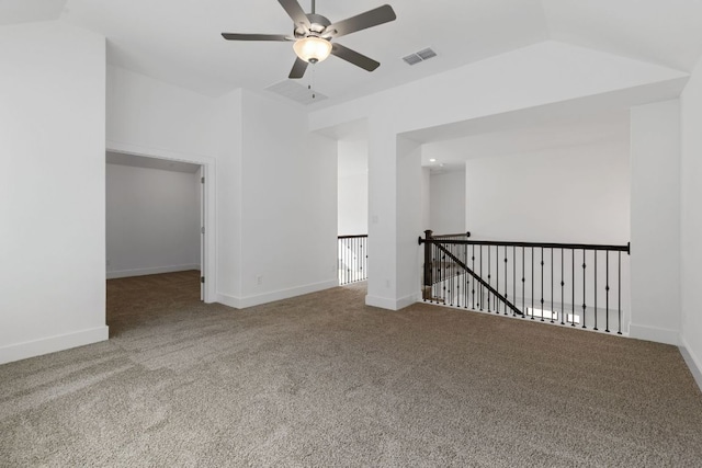 carpeted spare room featuring a ceiling fan, visible vents, and baseboards