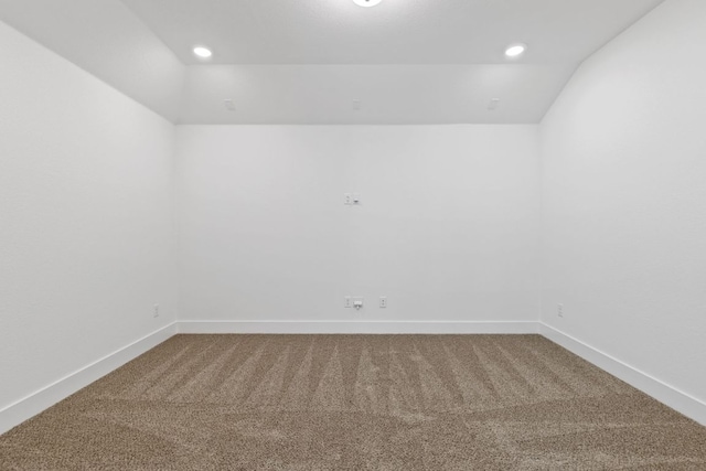 empty room with carpet, vaulted ceiling, baseboards, and recessed lighting