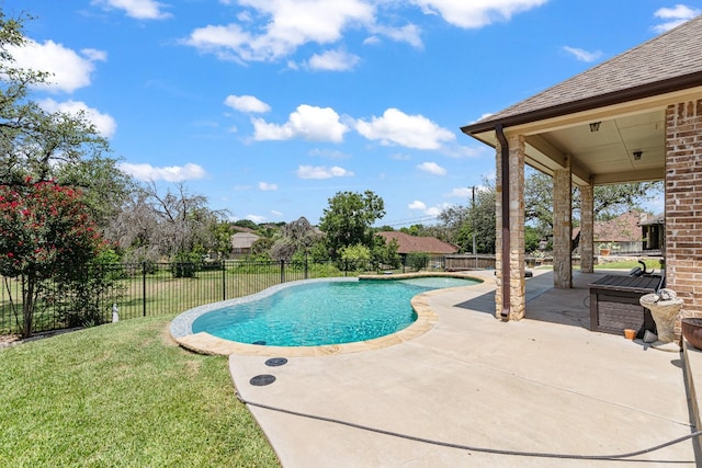 view of pool featuring a lawn and a patio