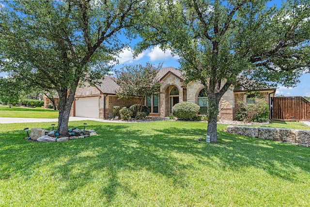 view of front of home featuring a front yard and a garage