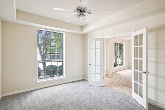 17006 Brewer Blackbird Dr, Pflugerville, TX 78660 - spare room with french doors, carpet flooring, a raised ceiling, and a ceiling fan