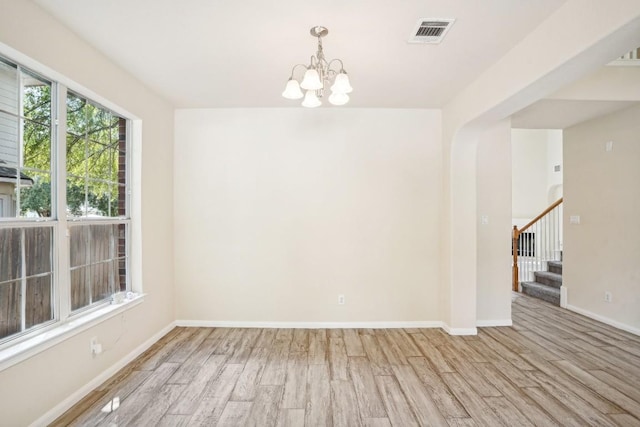 17006 Brewer Blackbird Dr, Pflugerville, TX 78660 - spare room with wood finished floors, a chandelier, and stairway