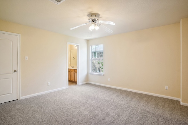 unfurnished bedroom featuring carpet, ensuite bath, and ceiling fan