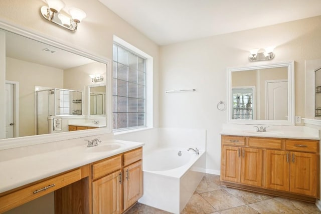 17006 Brewer Blackbird Dr, Pflugerville, TX 78660 - bathroom with a bath, two vanities, a stall shower, and tile patterned floors