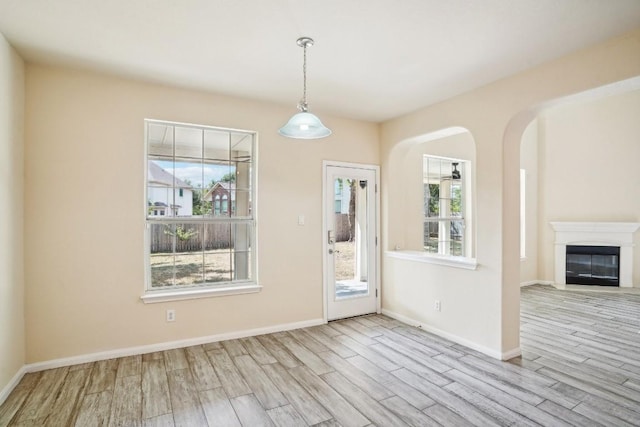 17006 Brewer Blackbird Dr, Pflugerville, TX 78660 - entrance foyer with wood finished floors, arched walkways, and a glass covered fireplace