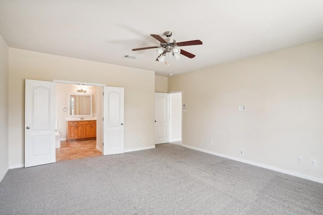 17006 Brewer Blackbird Dr, Pflugerville, TX 78660 - unfurnished bedroom with light carpet, connected bathroom, and ceiling fan