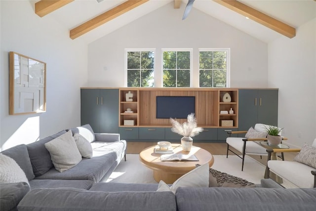 living room with vaulted ceiling with beams and hardwood / wood-style floors