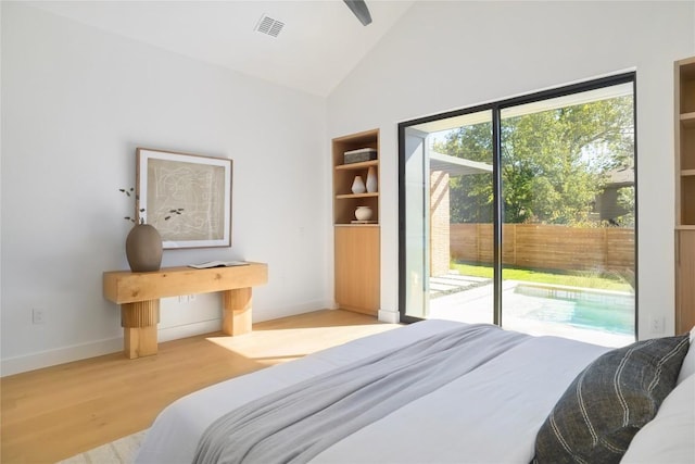 bedroom with lofted ceiling, access to outside, and light wood-type flooring