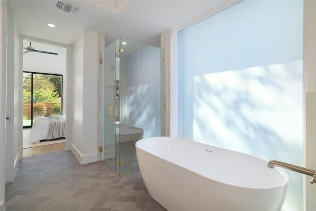 bathroom featuring shower with separate bathtub