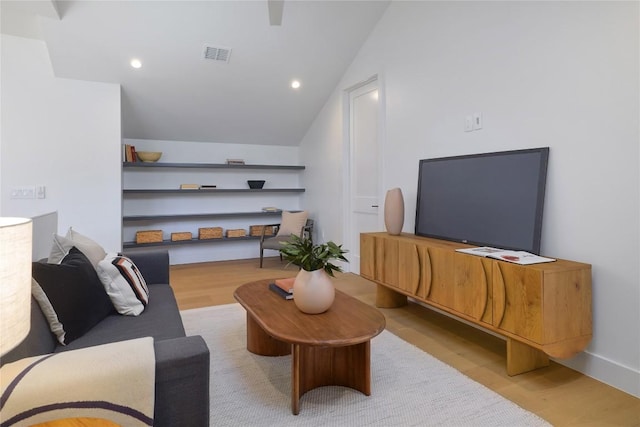 living room with lofted ceiling and light hardwood / wood-style flooring