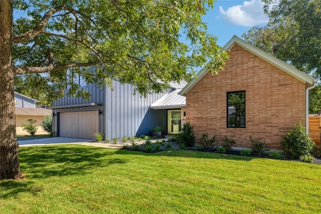 view of front of home featuring a garage and a front lawn