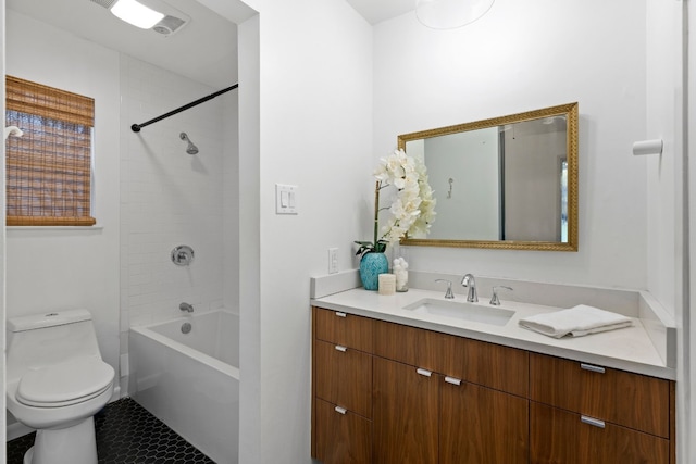 full bathroom with tile patterned floors, vanity, toilet, and tiled shower / bath combo