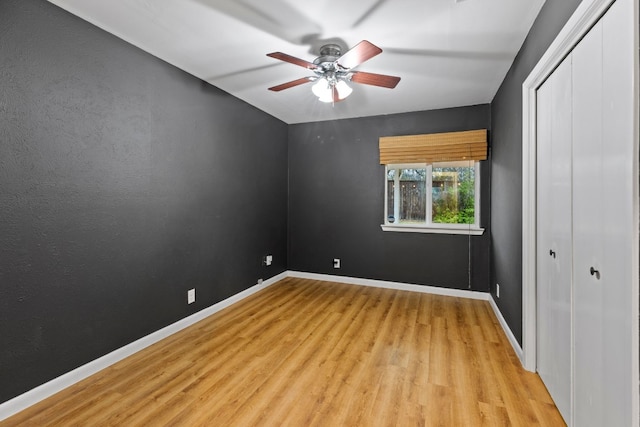 unfurnished bedroom featuring light wood-type flooring and ceiling fan