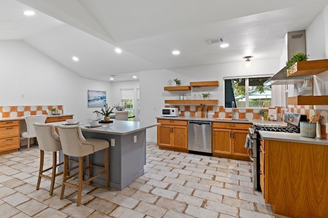 kitchen featuring a center island, stainless steel appliances, plenty of natural light, and sink