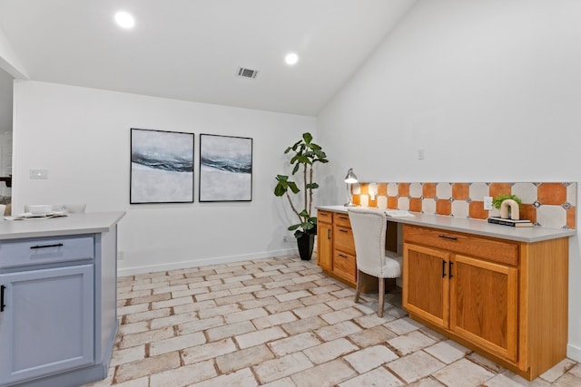 office area with vaulted ceiling