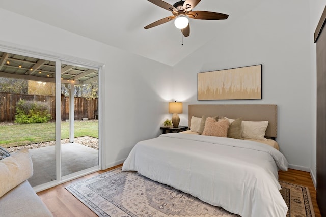 bedroom featuring access to exterior, ceiling fan, light hardwood / wood-style floors, and vaulted ceiling