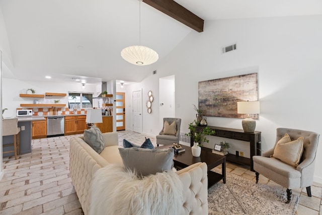 living room featuring beamed ceiling and high vaulted ceiling