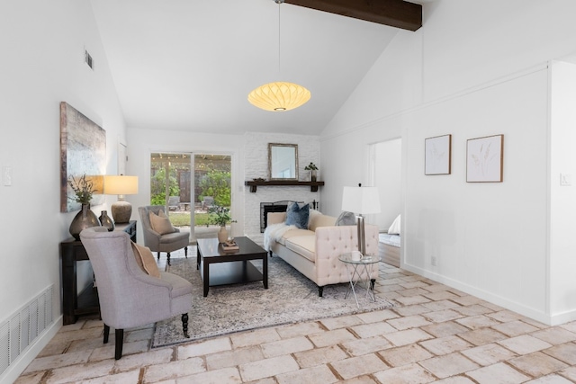 living room with beamed ceiling, a brick fireplace, and high vaulted ceiling