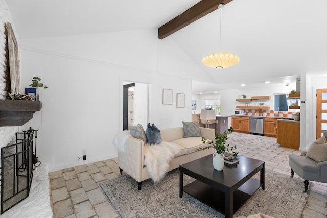 living room featuring lofted ceiling with beams and a fireplace