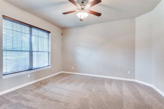 spare room featuring ceiling fan, a healthy amount of sunlight, and light carpet