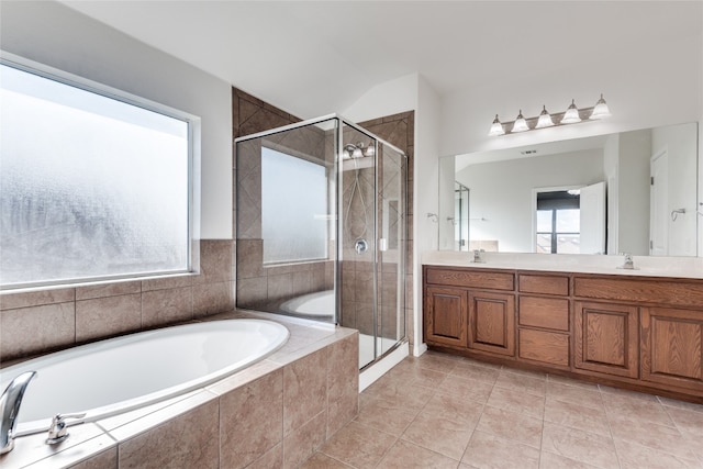 bathroom featuring tile patterned floors, vanity, and shower with separate bathtub