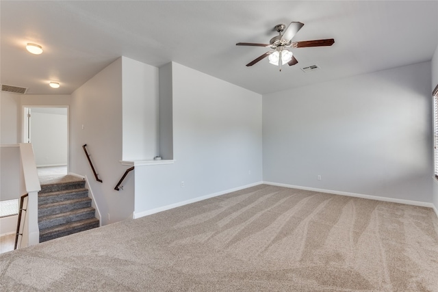 unfurnished living room featuring carpet flooring and ceiling fan